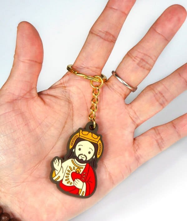 Jesus keychain on a hand for size comparison