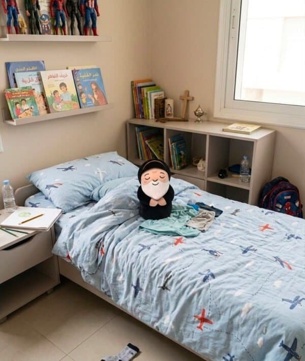 Saint Charbel plushie on a bed in a Maronite's kid room