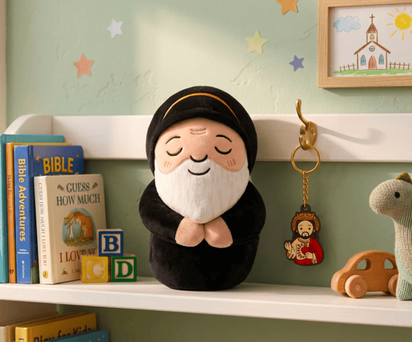 Saint Charbel plush toy and Jesus keychain on a shelf in a child's room