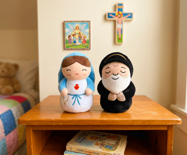 Virgin Mary and Saint Charbel plush toys on a desk