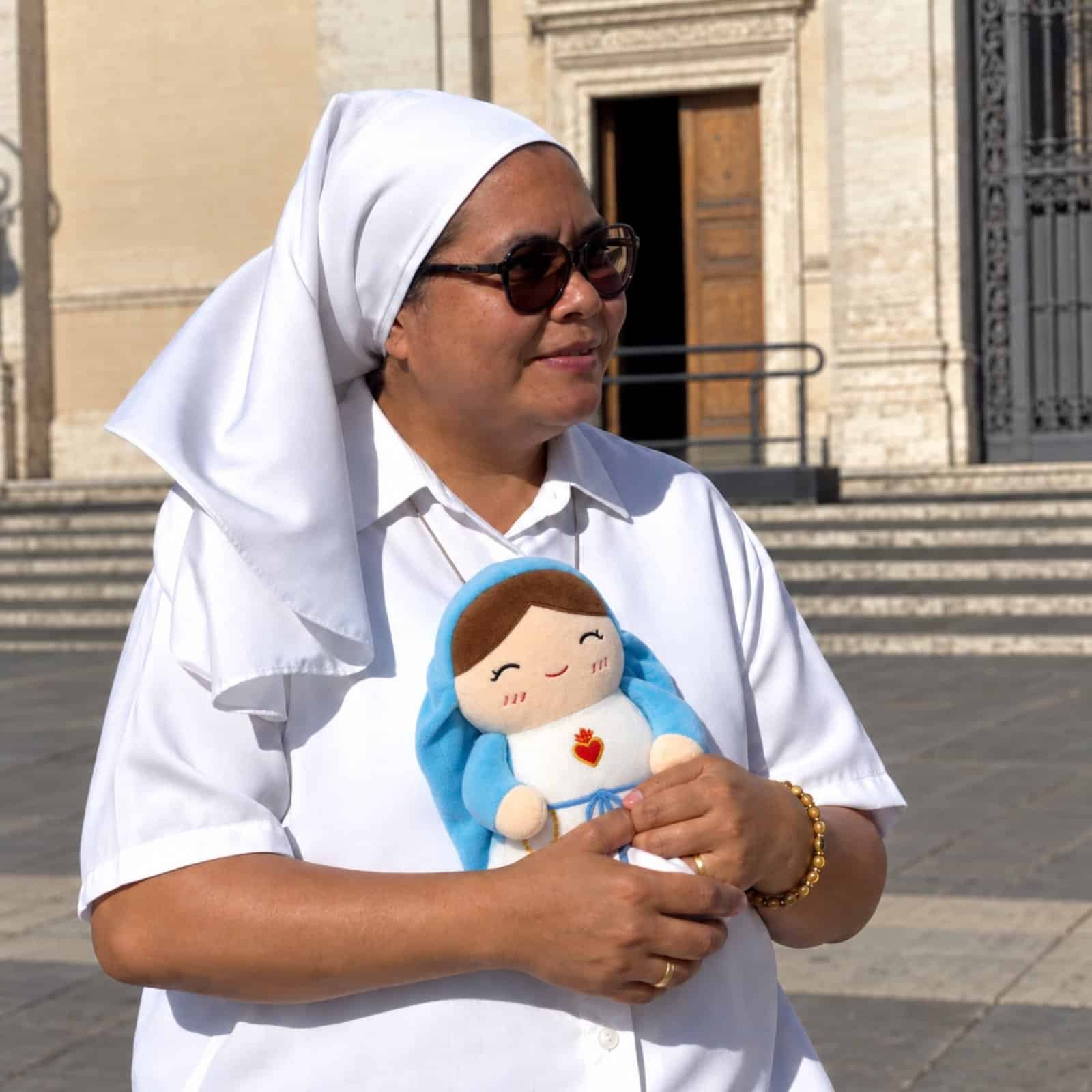 Sister Jeanne holding the Mary plushie outside a church in Rome